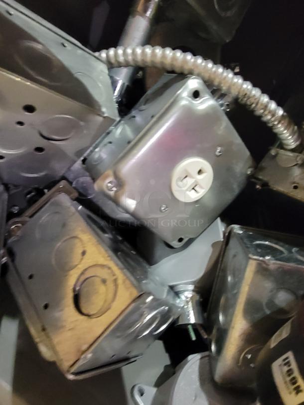 Industrial electrical enclosures and junction boxes lot, featuring galvanized steel and pre-installed outlets, IP69K-rated beacon.