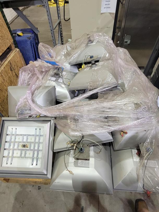 LSI Industries Crossover XPGP LED canopy lights on two pallets. Industrial-grade, wet location rated, energy-efficient luminaires.