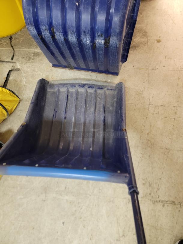 Lot of 9 Garant EPSS24U snow pushers, 24-inch poly scoops, ergonomic U-handles, heavy-duty, cold-resistant blades.