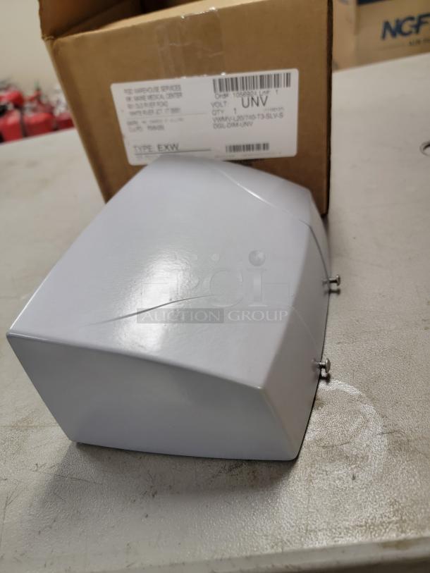 Alt text: H.E. Williams LED wall light with satin aluminum finish and micro-prismatic glass lens, shown next to packaging box.