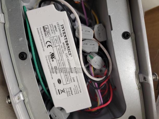 H.E. Williams Voltaire LED wall light interior showing Inventronics LED driver, model LUC-042S050DSP, with wiring visible.