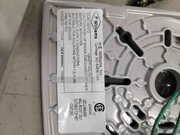 H.E. Williams LED wall light with satin aluminum finish and IP65 rating. Model VWMV-L20/740-T3-SLV-S, CSA certified for wet locations.
