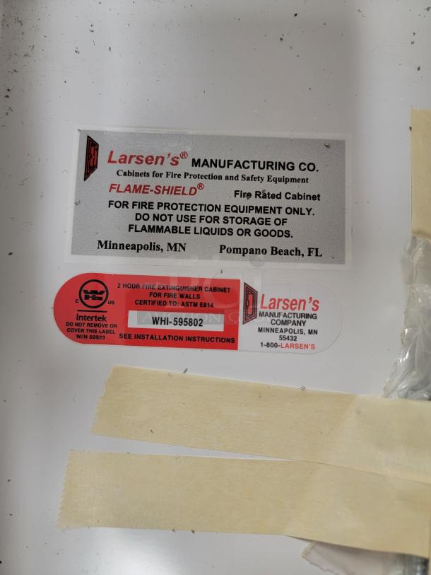 Larsen's Flame-Shield labels on WHI-595802 fire-rated extinguisher cabinet, showing certification and installation details.
