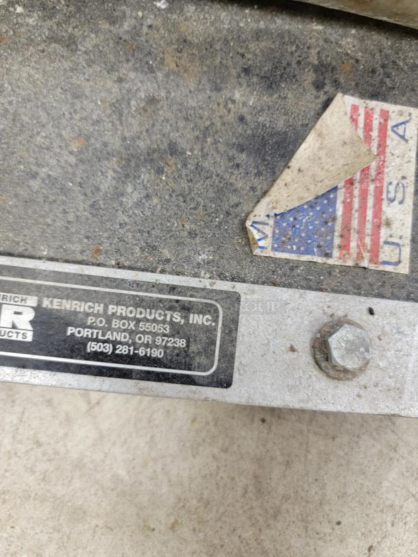 Kenrich Grout Pup GP-2 hand pump. Durable design, 5-gallon hopper, USA-made. Label reads: Kenrich Products, Portland, OR.