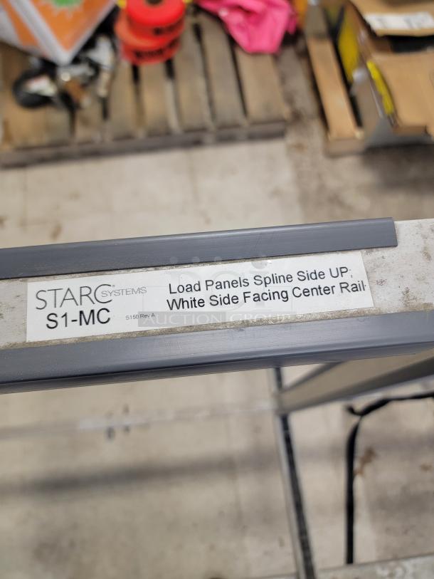 STARC Systems S1-MC mobile carrier with label indicating panel loading instructions. Rugged aluminum frame and protective rails.