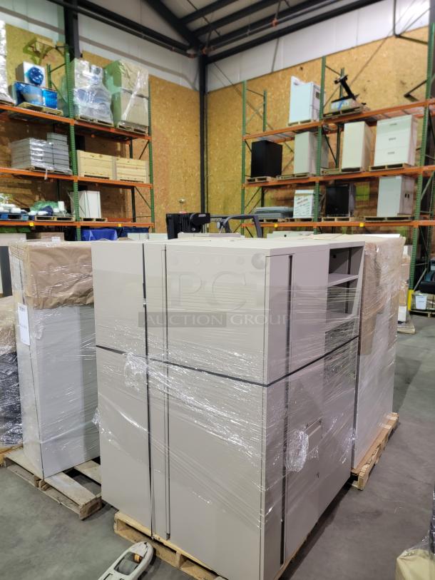 Commercial-grade steel cabinets on pallets. Includes lateral files, vertical lockers, and shelves. Heavy-gauge steel, neutral finish.