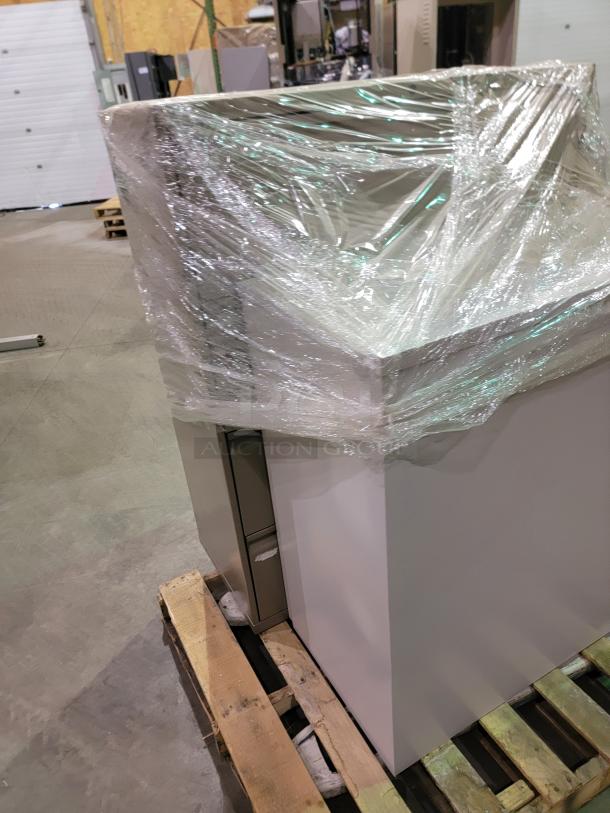 Commercial-grade steel storage cabinets wrapped on a pallet. Features lateral files and lockers with powder-coated finish.