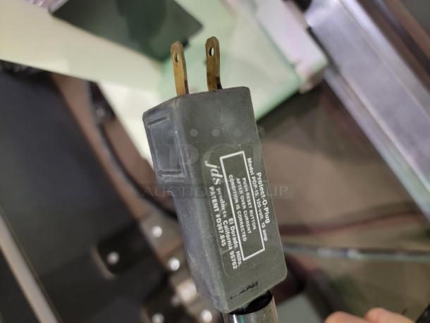 JDS Protect-O-Plug surge protector with visible label, detailing 120 volts and 15 amp specifications.