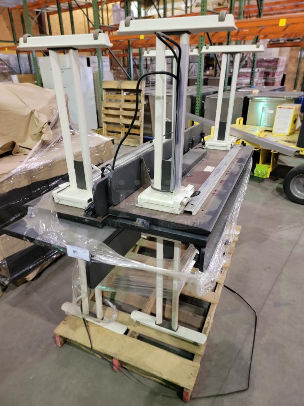 Lot of 4 KI Krueger International Synthesis nesting training tables with Graphite Nebula tops, flip-top mechanism, T-leg base, casters, pop-up power modules, and surge protection.