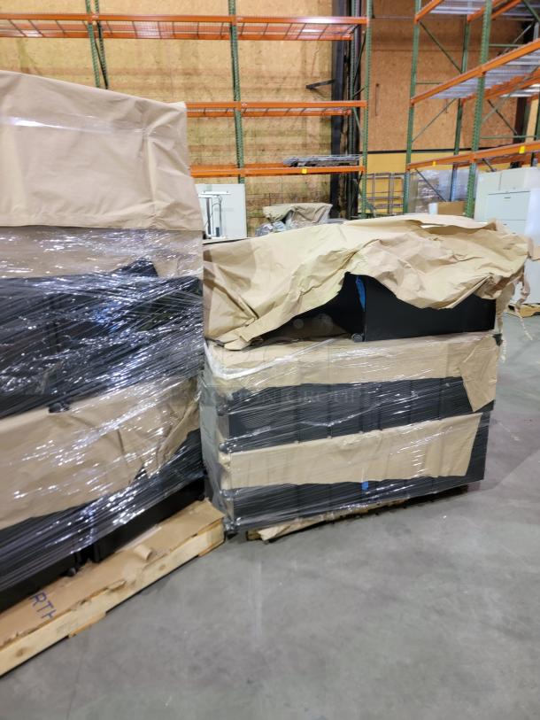 Bulk lot of HP M2705A mobile storage pedestals on two pallets with protective wrapping, featuring heavy-duty steel and casters.
