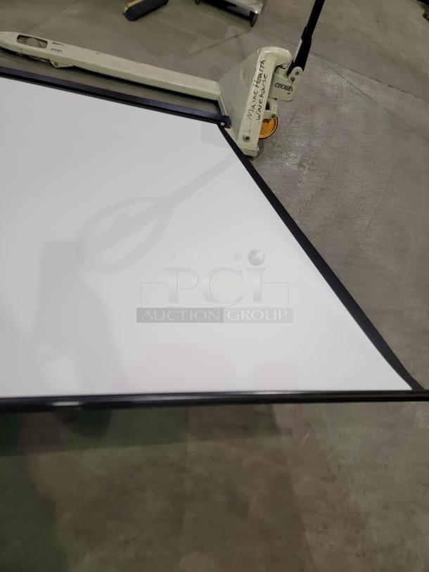 Quartet 7' projection screen with matte white surface, black metal housing, pull-down mechanism, and mounting hardware.