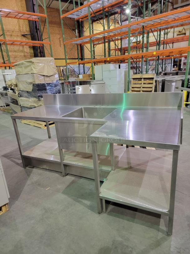 Heavy-duty stainless steel prep table with 24-inch deep bowl sink, backsplash, undershelf, reinforced legs, and adjustable feet.