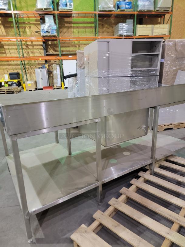 Heavy-duty stainless steel commercial prep table with 24-inch deep bowl sink, backsplash, and undershelf. Reinforced legs.