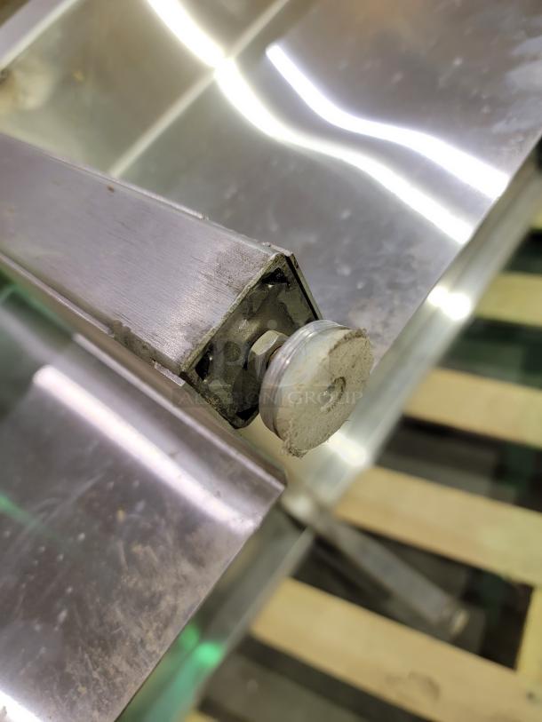 Heavy-duty stainless steel prep table corner and adjustable foot. Features durable construction and sanitation-focused design.