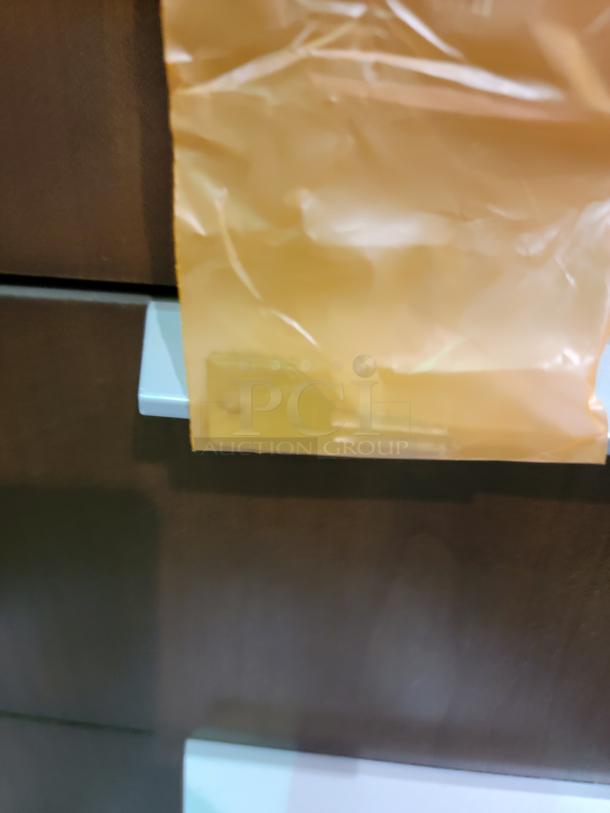 Healthe locking cabinet with dark wood veneer, white chassis, features integrated lock with key, shelving, and deep drawers.