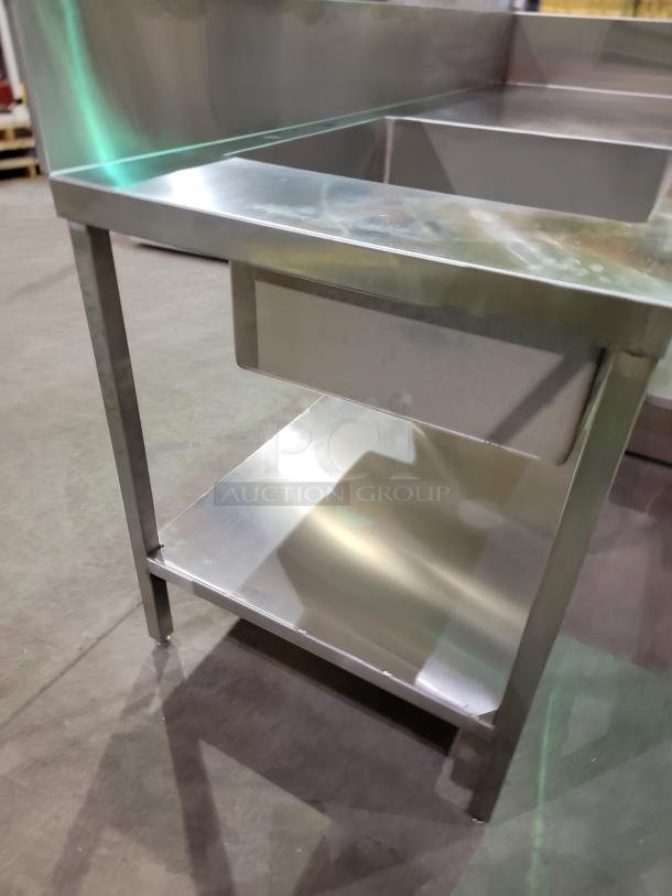 Heavy-duty stainless steel L-shape prep station with integrated sink, 8-inch backsplash, and undershelf. Ideal for high-volume use.