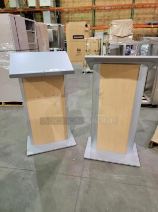 Dynamicflex DF-200 kiosks with wood-grain panels, silver finish, tilted ergonomic surface, and clear acrylic rear shelf.