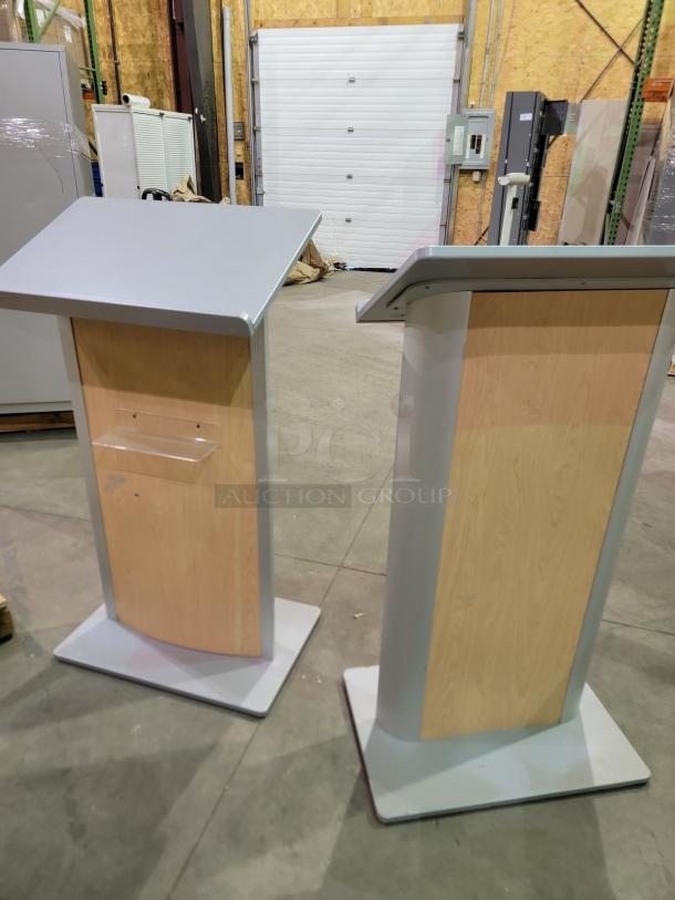 Dynamicflex DF-200 kiosks with wood-grain panels, silver finish, ergonomic tilt, durable metal base, and rear acrylic shelf.