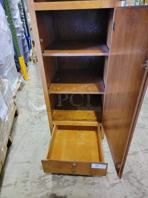 Solid wood storage cabinet with honey-oak finish; two compartments, adjustable shelves, smooth bottom drawer, classic knobs.