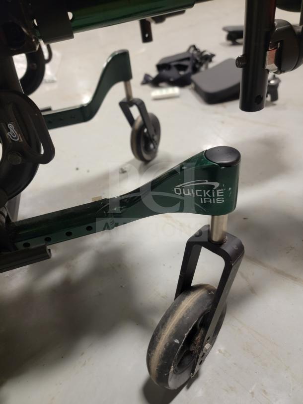 Premium Quickie IRIS Tilt-in-Space Wheelchair with custom seating, logo visible. Features smooth tilt, JAY backrest, leg rests.