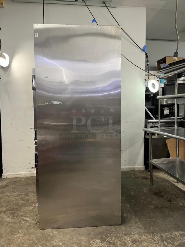 TRAULSEN RHT232NUT stainless steel refrigerator, 46 cu. ft., two-section, half-door, narrow, in good condition.