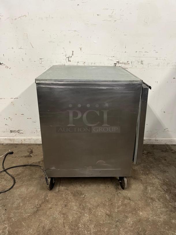 Beverage-Air 27" undercounter refrigerator, stainless steel, good condition, on casters, minor surface wear evident.