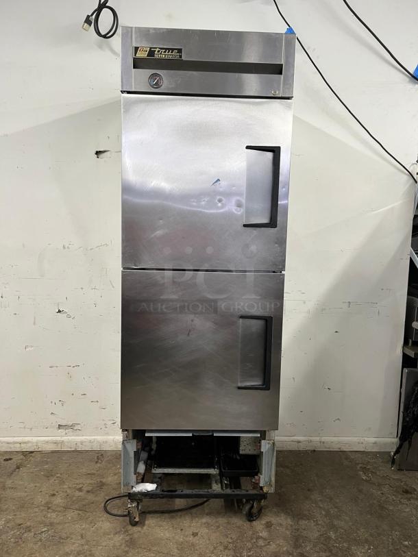 TRUE T-23-2 27" reach-in refrigerator with two left-hinge solid doors. Features visible brand label and dial gauge.