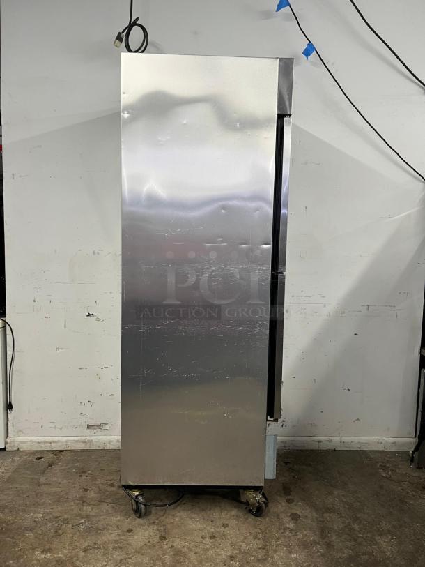 TRUE T-23-2 refrigerator, 27" reach-in, two solid left-hinge doors, visible wear on stainless steel, 115v, mounted on casters.