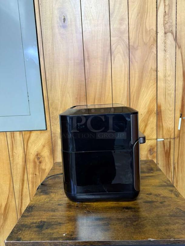 Instant Pot Vortex Plus 10 Quart Air Fryer Oven in black, model Vortex Plus, in good condition on a wooden surface.