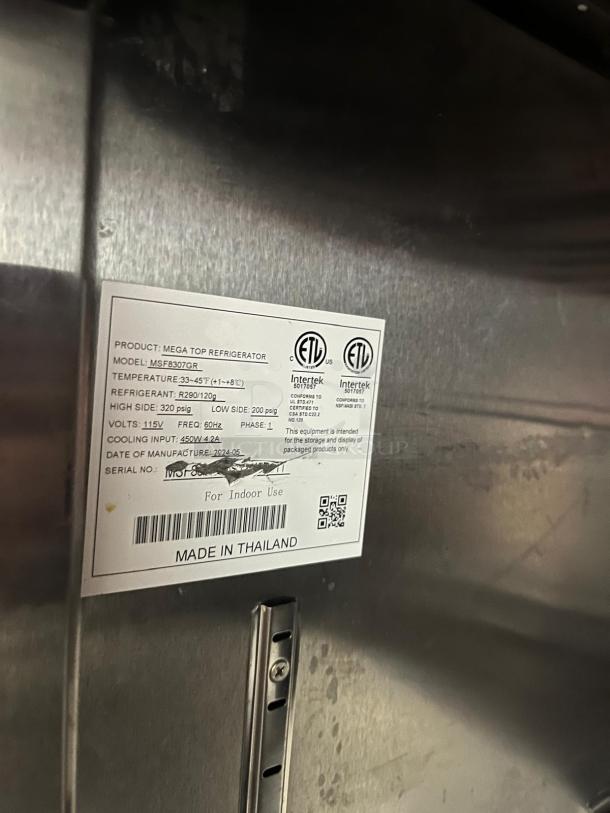 Label on Atosa MSF8307GR 60" Double Door Sandwich/Salad Mega Top Prep Table, indicating model, temperature range, and manufacture details.