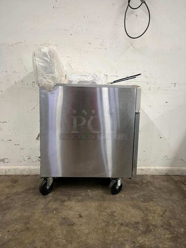 BRAND NEW Atosa ATFS-50 gas fryer, stainless steel, 50 lb capacity, 4 burners, caster wheels, packaging intact.