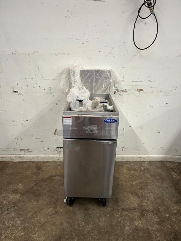 BRAND NEW Atosa ATFS-50 CookRite 50 lb gas fryer with 4 burners, stainless steel, unused, packaging intact, on wheels.