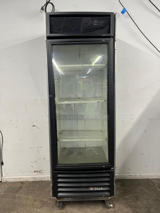 TRUE GDM-19T-LD 27" black refrigerated glass door merchandiser with LED lighting, travel case included.