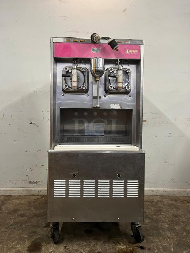 Taylor 342D-27 double flavor frozen drink machine in used condition, with dispensers, wheels, and branding for Dunkin' Donuts and Wicked Frozen Cocktails.