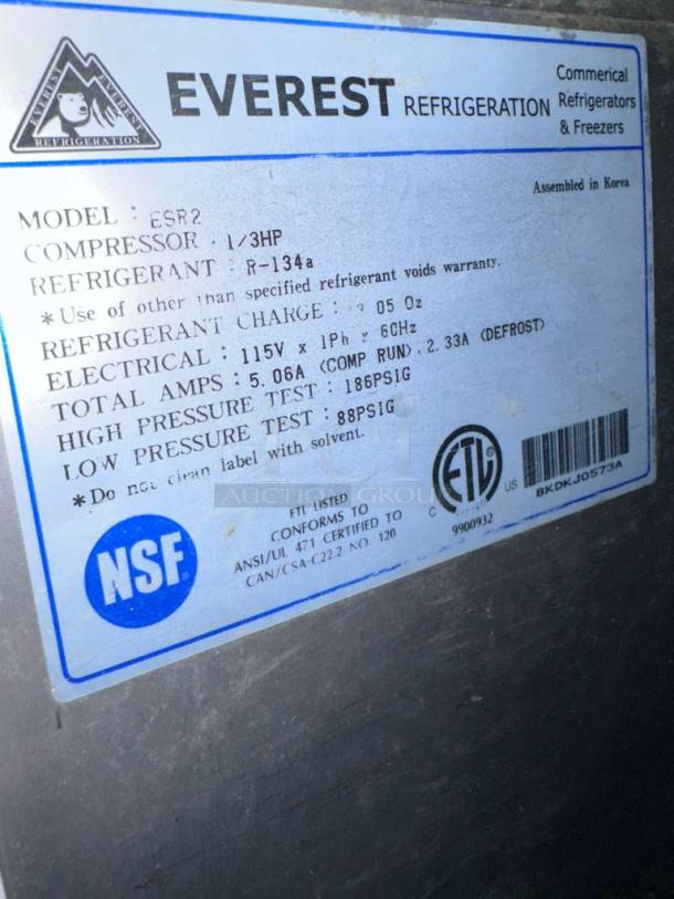 	NSF and ETL labels on Everest ESR2 commercial refrigerator, showing model details and specification list, ensuring compliance and operational status.