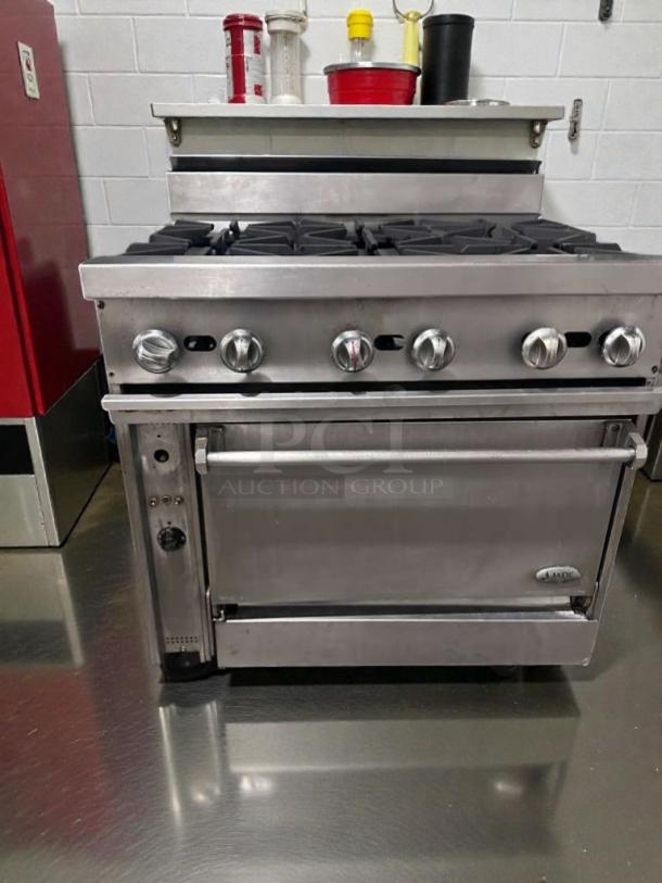 Stainless steel 6-burner gas range with oven, model COM-L-RNG-0509, by Commercial Restaurant Equipment. Superior condition.