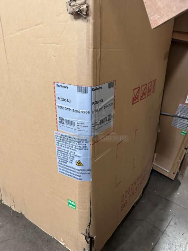 Sealed box of KoolMore RD32C-SS refrigerated display case. Labels show model and safety instructions. Brand new condition.