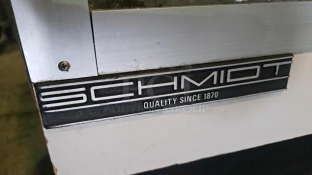 The C. Schmidt EHD-4 refrigerated deli display case with curved glass, model number visible, "Schmidt Quality Since 1870."