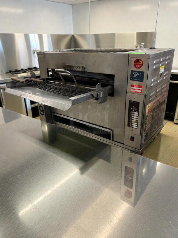 Duke Electric Conveyor Broiler Oven in immaculate condition, model DUK-L-BROIL-0527, shown in a commercial kitchen setting.