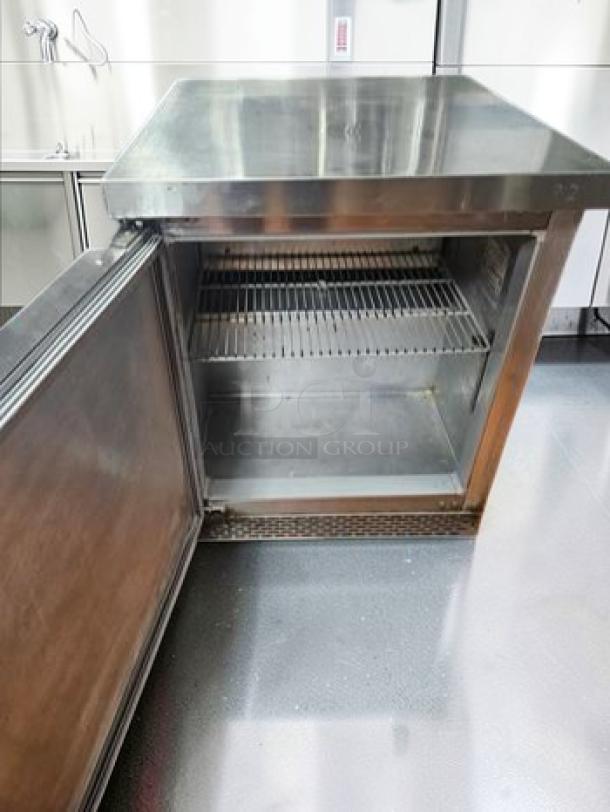Continental undercounter refrigerator, 1 door, stainless steel, commercial use, open view, shelves visible, excellent condition.