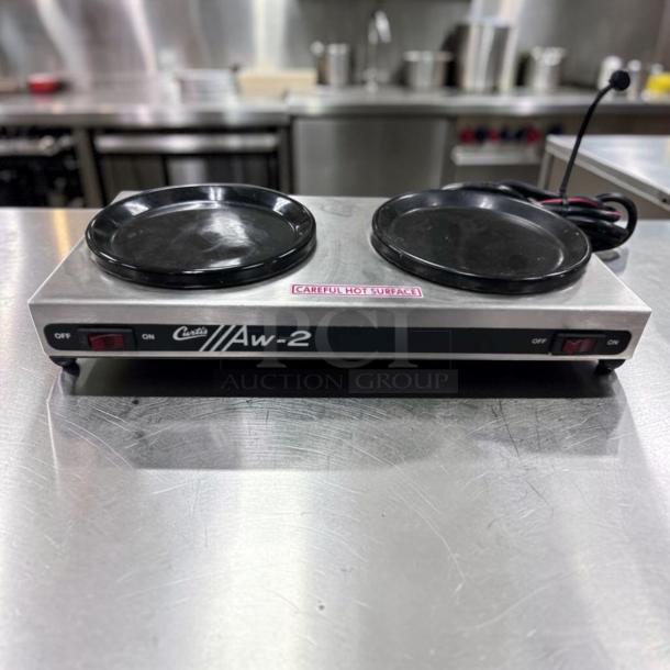 Curtis AW-2-10 two-burner coffee decanter warmer, stainless steel, 120V, excellent condition, "Careful Hot Surface" label.