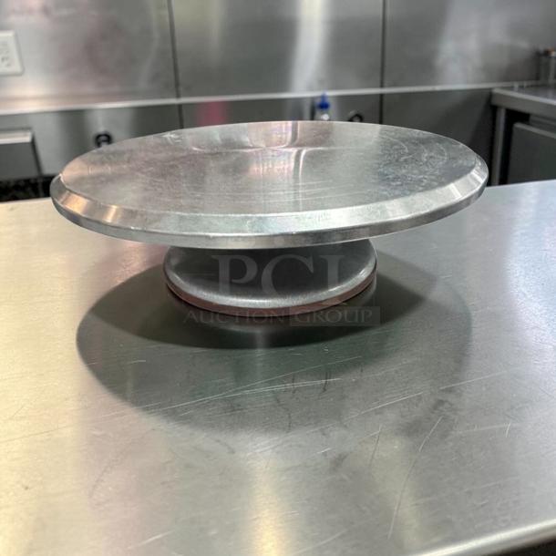 Stainless steel cake display stand, 12" diameter, commercial grade, excellent condition, ready for bakery use.