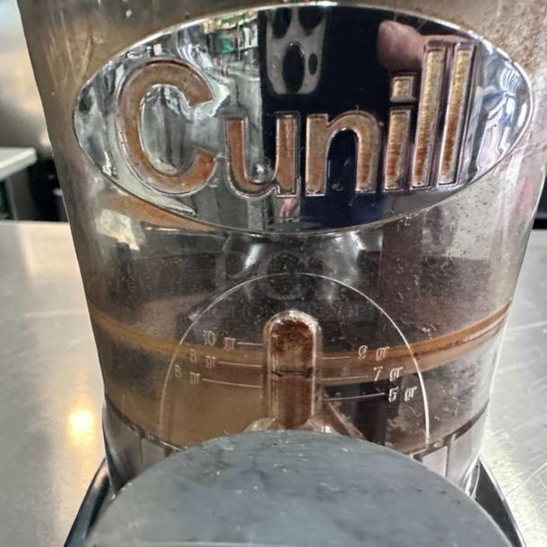 Cunill commercial coffee grinder, heavy-duty espresso model, made in Spain. Prime condition with quantity markings visible.