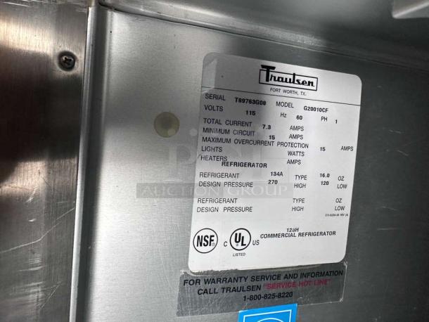Alt text: Prime Condition Traulsen G20010 Commercial Reach-In Refrigerator, 52" double door, stainless steel, fully tested, label details model, voltage, and refrigerant type.
