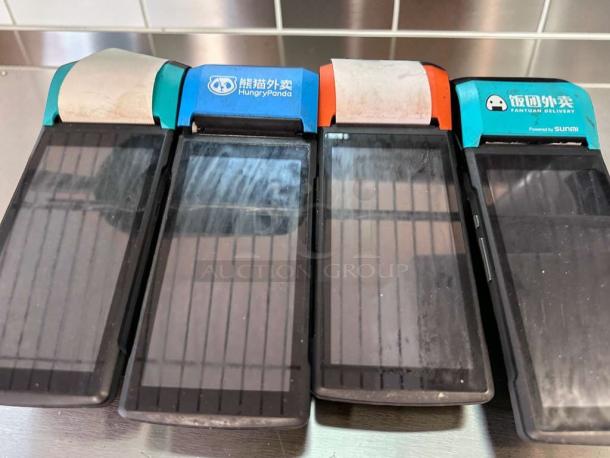 Set of 4 Sunmi V2 wireless POS terminals, built-in receipt printers, excellent condition, labels indicate various delivery services.
