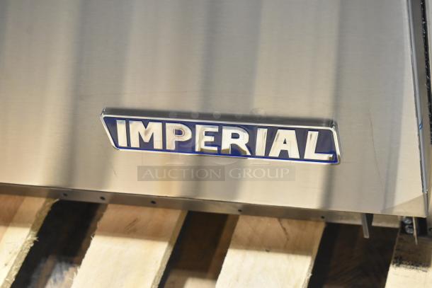 Stainless steel Imperial logo on the 2026 Imperial IR-6-E commercial electric range with visible minor scratches.