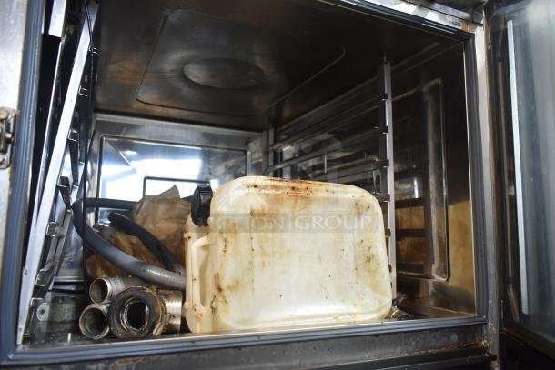 2021 Rational iCombi Pro LM100CE.AXXXX/LM100EE.AXXXX combi convection oven interior, includes hoses and cleaning container.