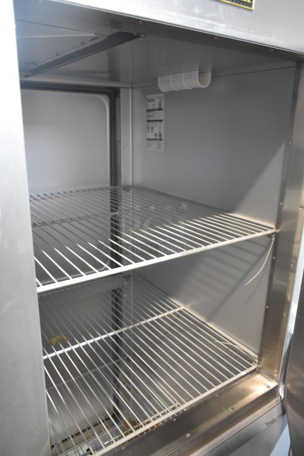 Brand new 2022 Traulsen G10042-032 commercial cooler, 2 half-size doors, interior view. Includes commercial casters.