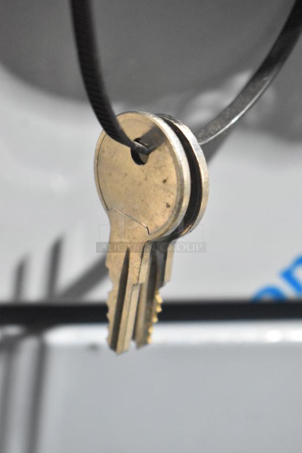 Close-up of keys attached to a wire. Part of the auction item Traulsen G10042-032 commercial cooler.