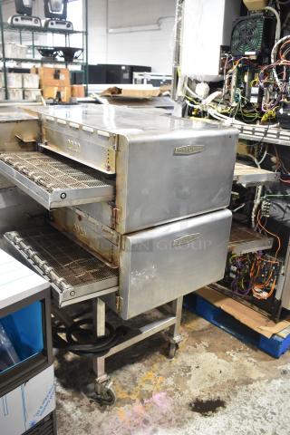 Two 2018 Turbochef HhC2020 commercial electric conveyor ovens with equipment stand, 208/240V, 3 Phase, used condition.